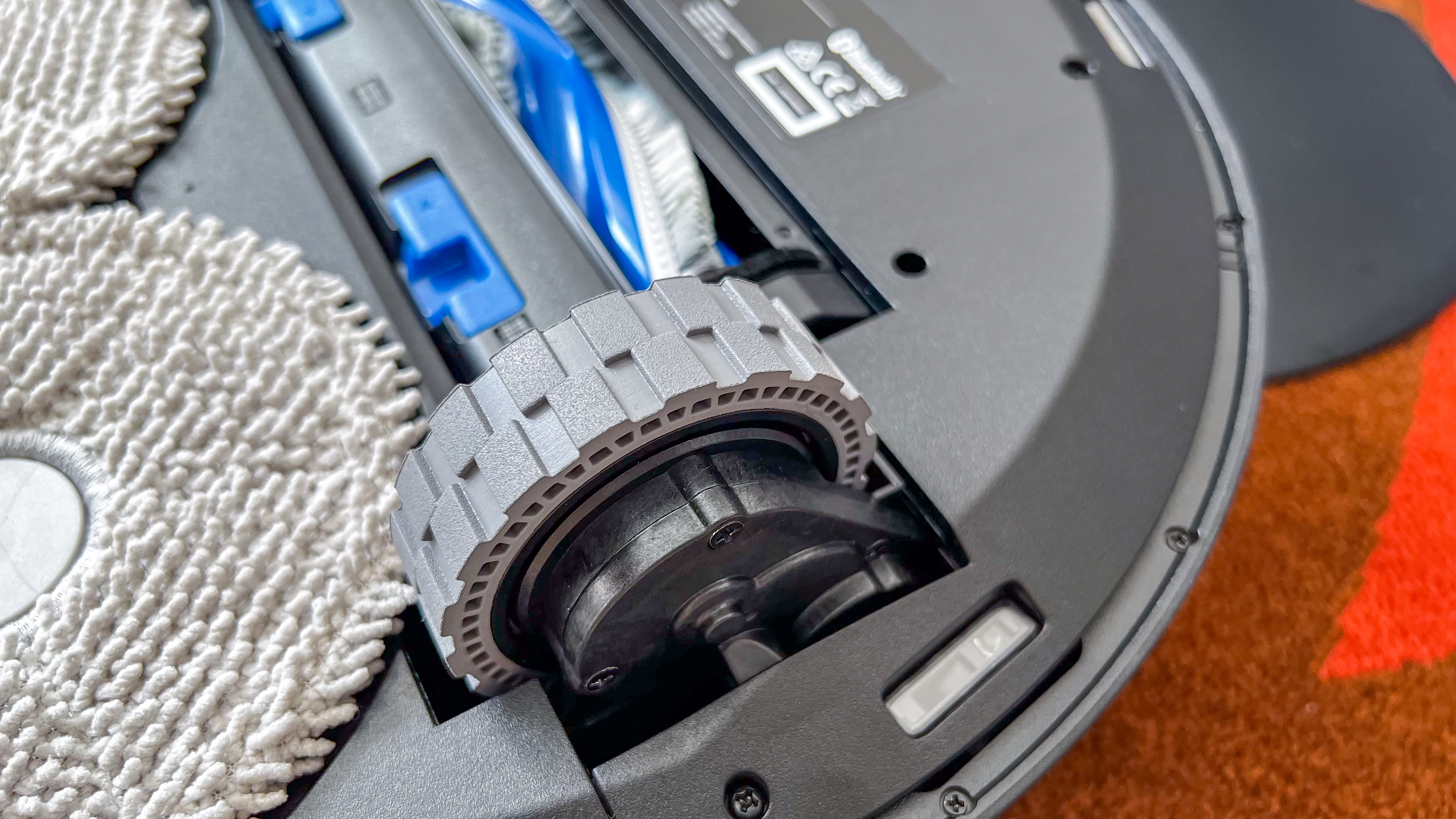 A wheel on the undercarriage of the Ecovacs Deebot T30 Omni robot vacuum