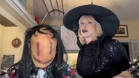 A masked Robert Fripp, and Toyah Willcox dressed as a witch, in their kitchen