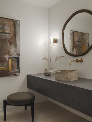 small bathroom with stone vessel sink by Joshua Smith
