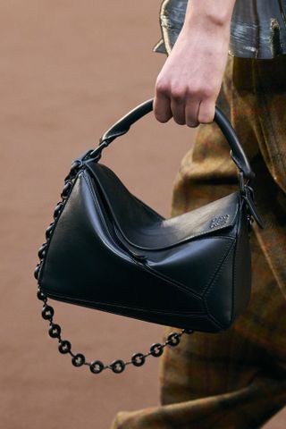 close-up shot of Loewe handbag in the model's hands on the runway