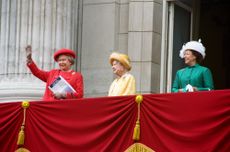 Queen Elizabeth, the Queen Mother and Princess Margaret waving from the balcony of Buckingham Palace in bright coats on the 50th anniversary of VE Day