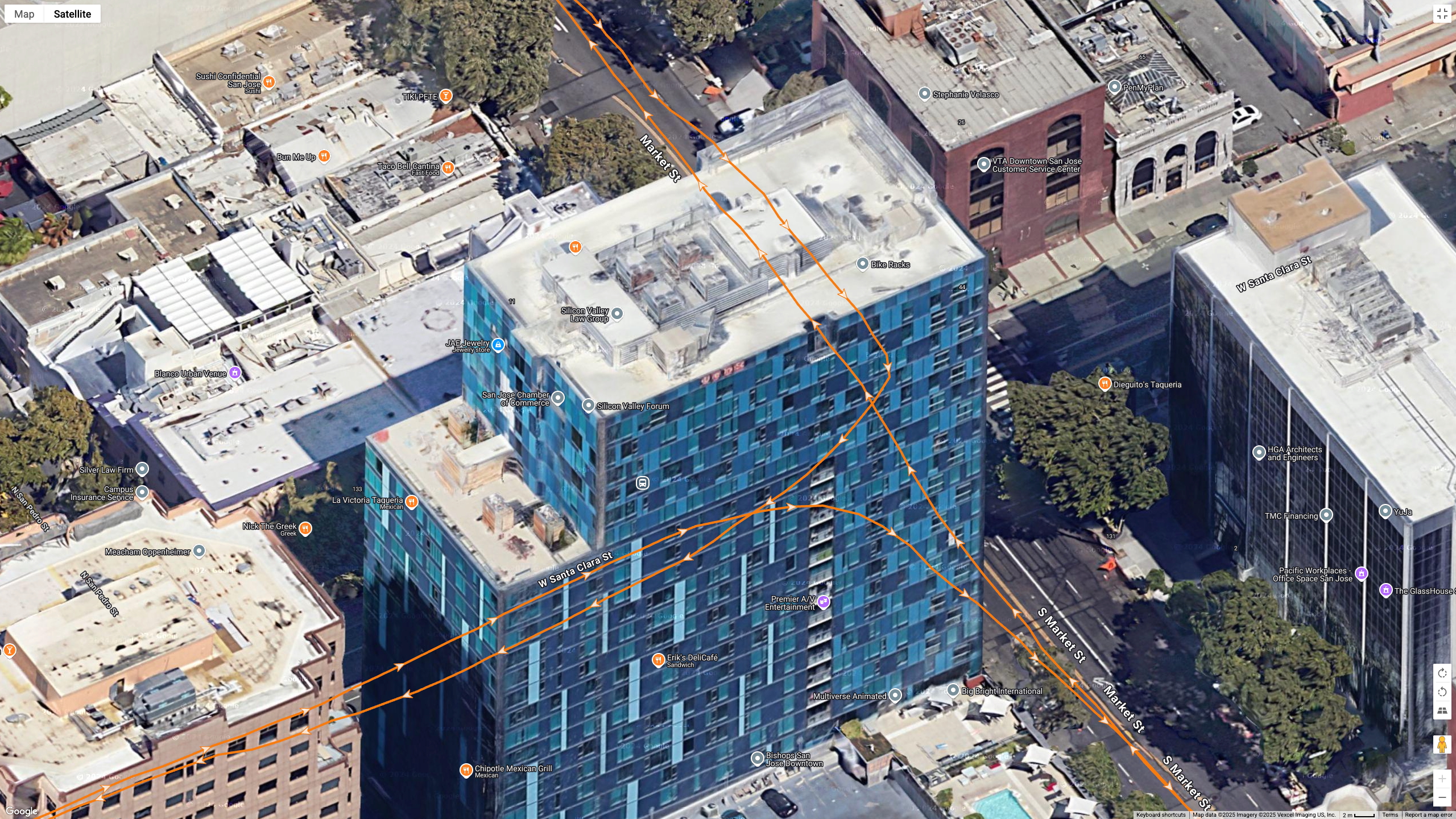 Google Maps satellite data showing how the Garmin Forerunner 970 (orange line) tracks my position during a race in downtown San Jose near tall buildings.