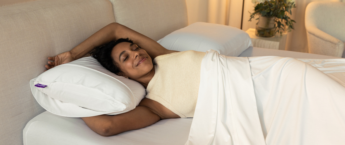 Woman sleeping on the Purple Harmony Pillow