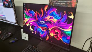 The MSI MPG 271QR QD-OLED X50 gaming monitor showing a colourful background at Computex 2025