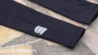 A pair of Sportful NoRain Arm warmers on a paved floor