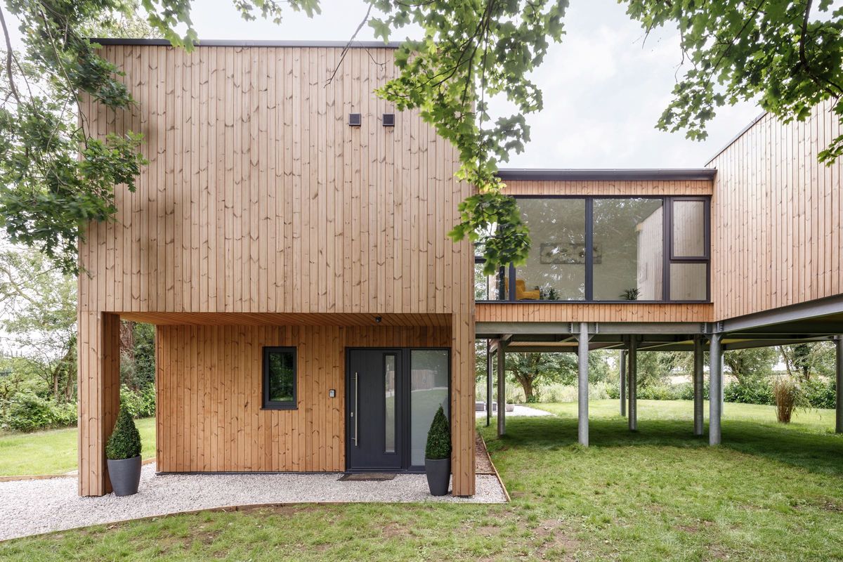 A timber cladded wall and pods supported by steel beams