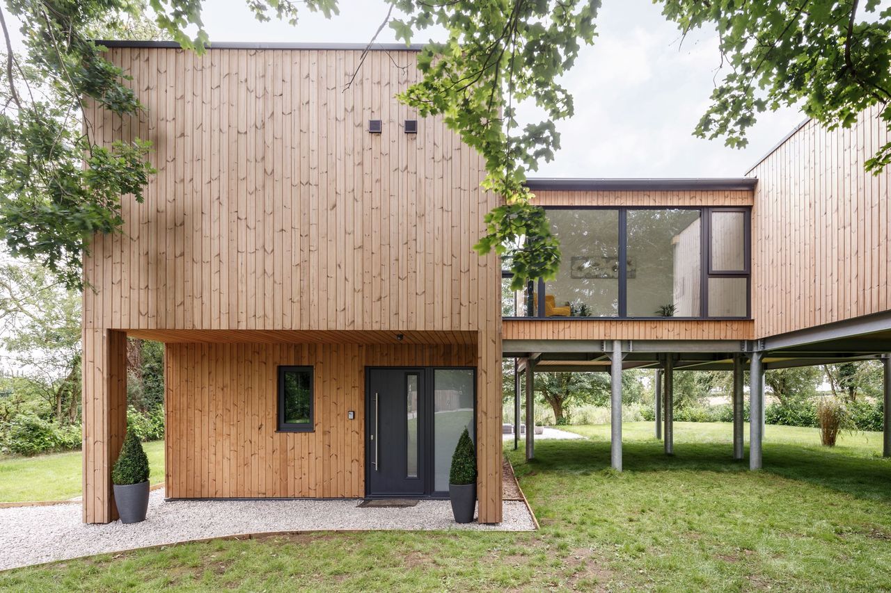 A timber cladded wall and pods supported by steel beams