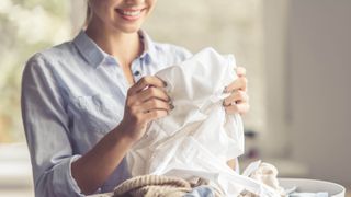 Woman holding white laundry