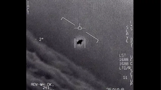 A black and white image of circular flying object