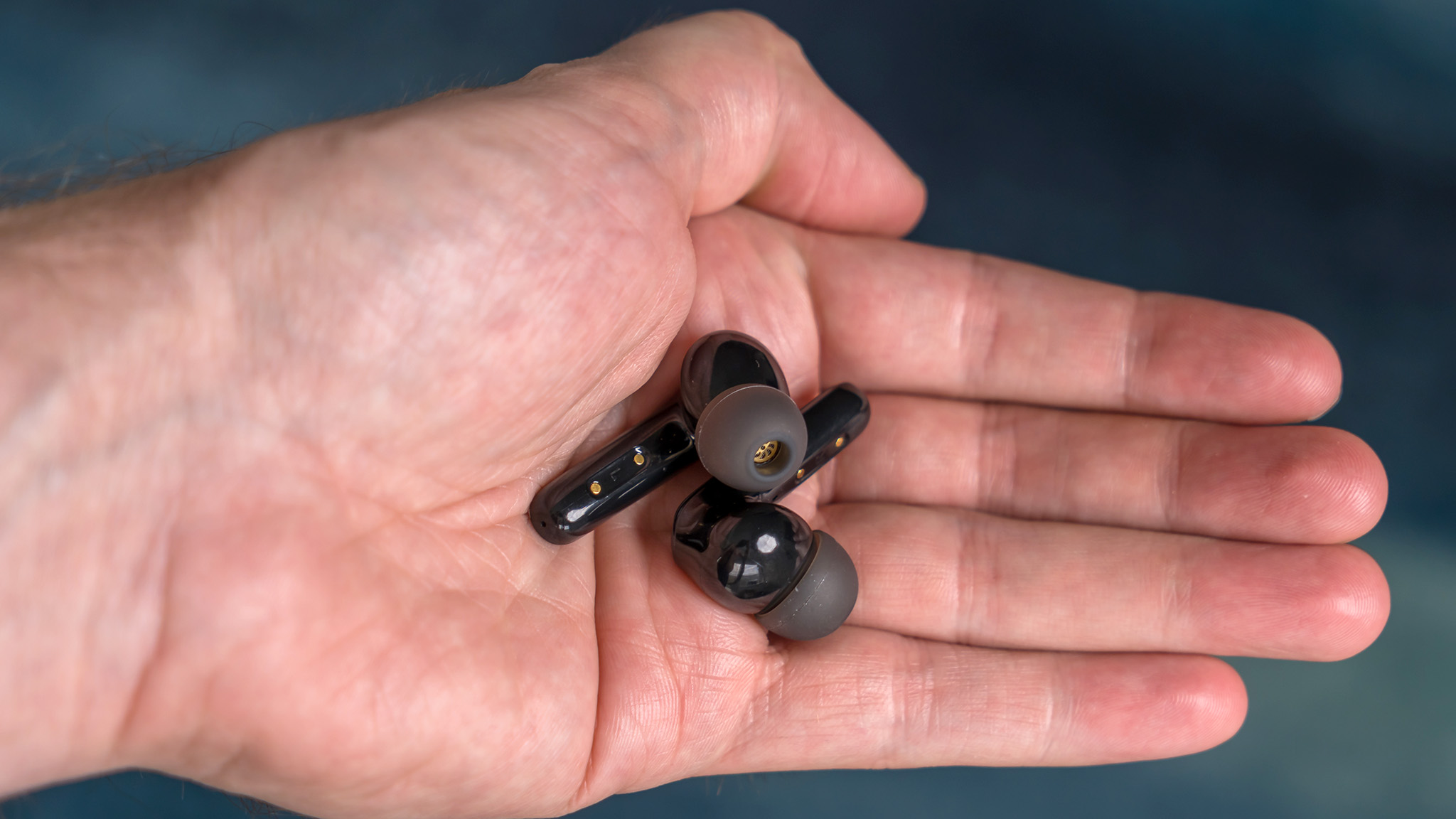 Anker Soundcore Life P3 earbuds in hand.