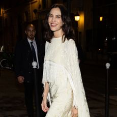 Alexa Chung wears a tassel dress with black curved heel shoes.