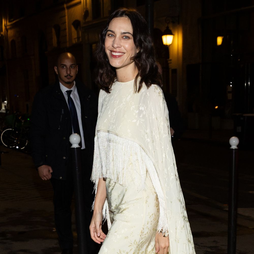Alexa Chung wears a tassel dress with black curved heel shoes.