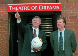 Manchester United manager Alex Ferguson, holding a football and pointing upwards, introduces Steve McClaren as his new assistant manager, February 1999