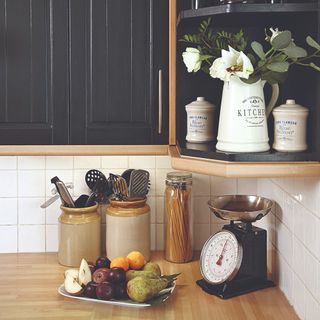 A kitchen worktop with black kitchen cupboards