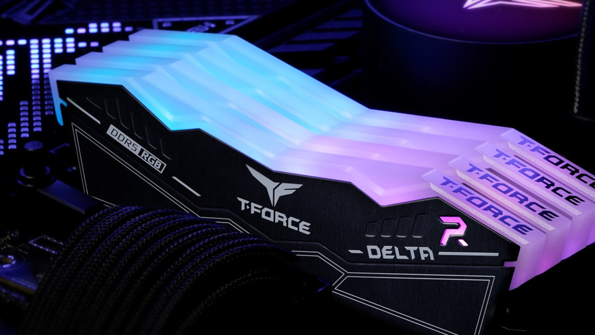 A promotional image from Team Group, showing four sticks of its T-Force DDR5 RAM in a motherboard