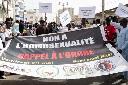 Protesters hold a placard reading "No to homosexuality, call to order" during a demonstration calling for the criminalization of homosexuality in Senegal,