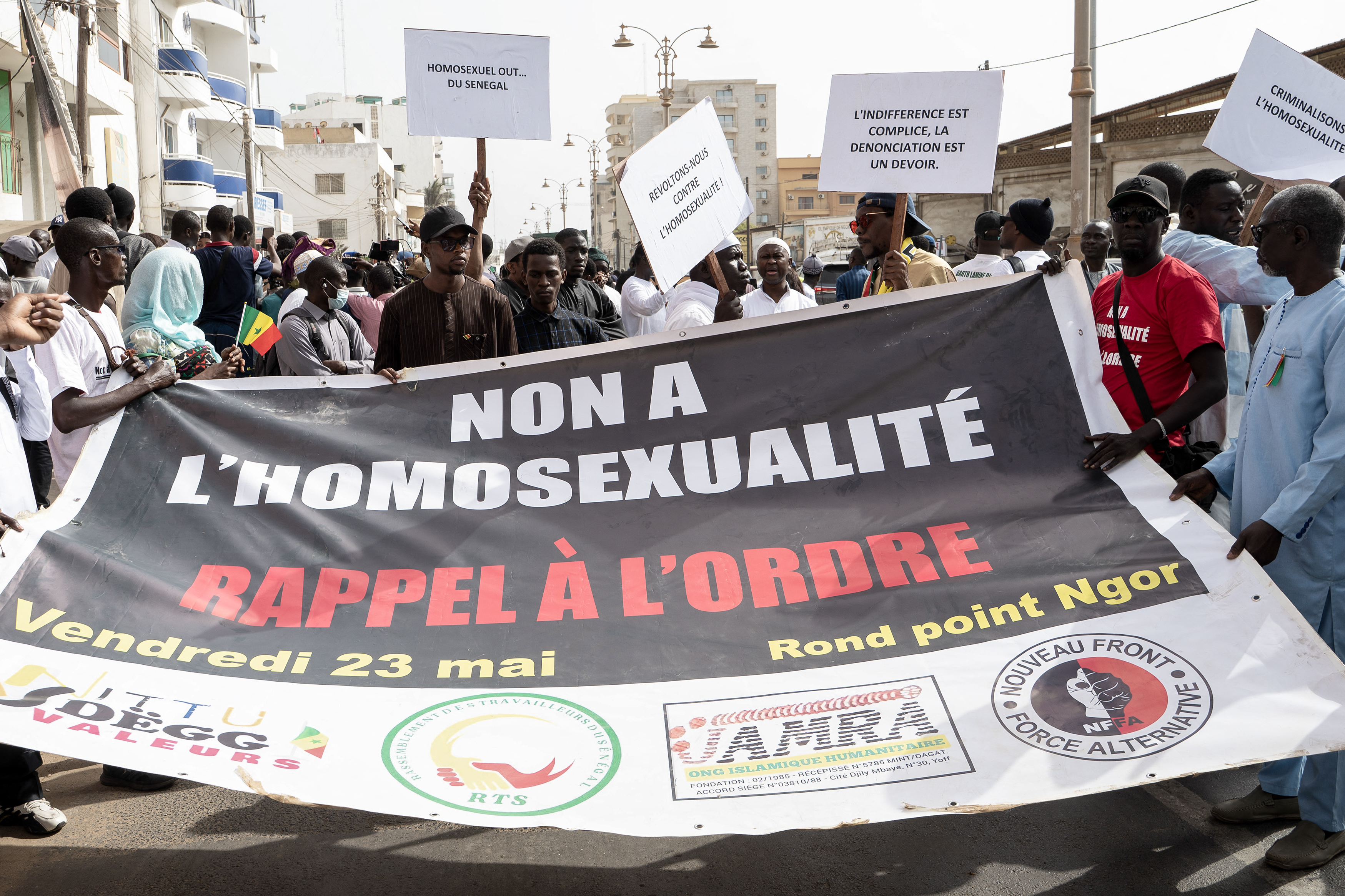 Protesters hold a placard reading "No to homosexuality, call to order" during a demonstration calling for the criminalization of homosexuality in Senegal,