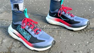 Person wearing the Hoka Tecton X3 trail running shoes outside