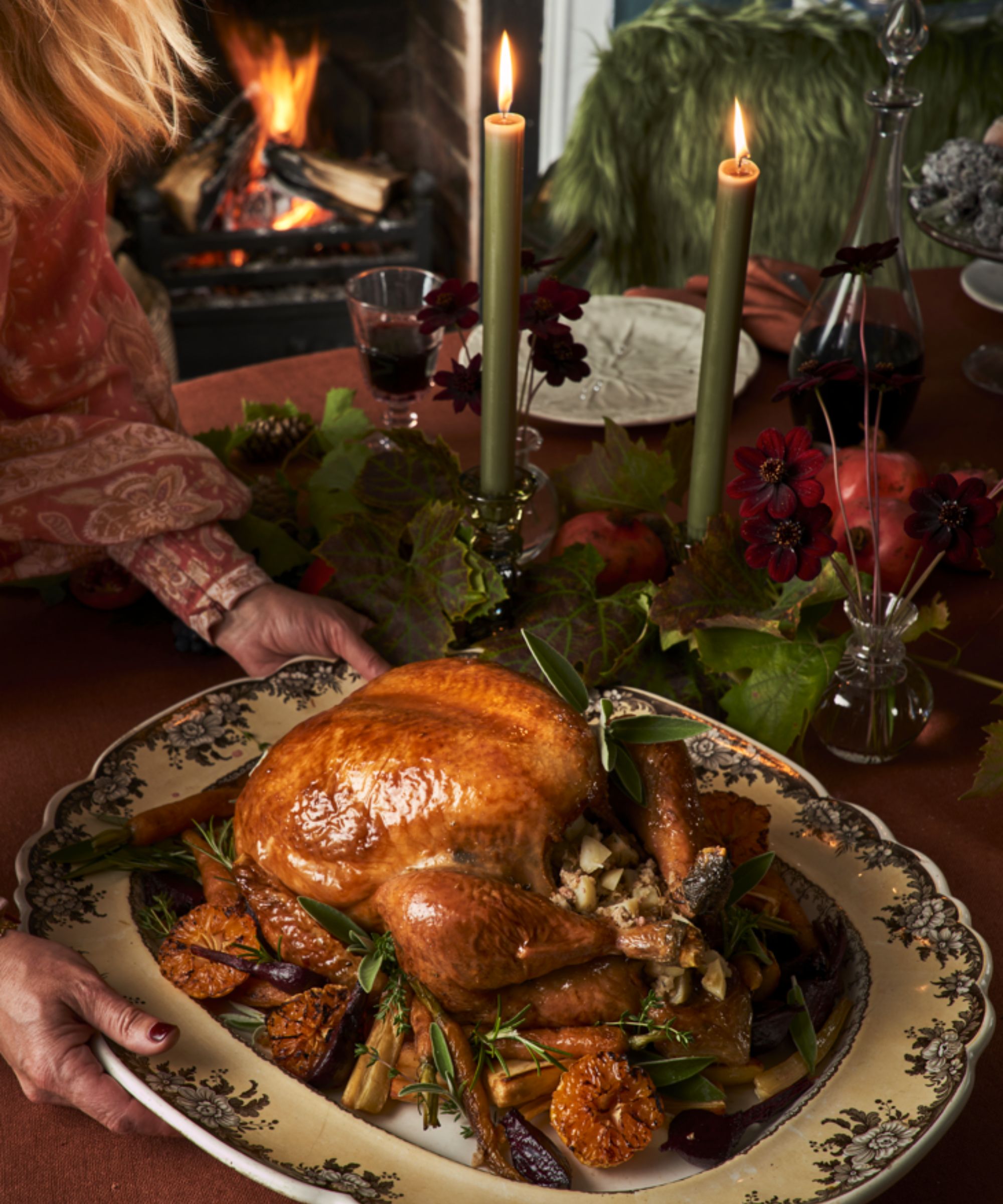 Floral platter with roast chicken on dark burgundy tablecloth