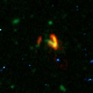 A composite image shows ALMA data of the two galaxies of SPT0311-58 in red. These galaxies are shown over a background image from the Hubble Space Telescope.