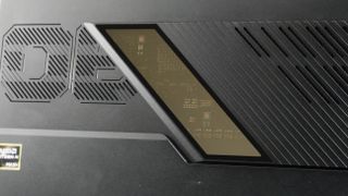 Asus ROG Flow Z13 (2025) up against a white wall, highlighting the glass pane on its back, revealing the internals.