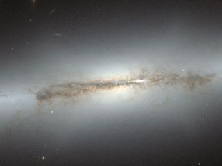 This image from the NASA/ESA Hubble Space Telescope shows edge-on galaxy NGC 4710.