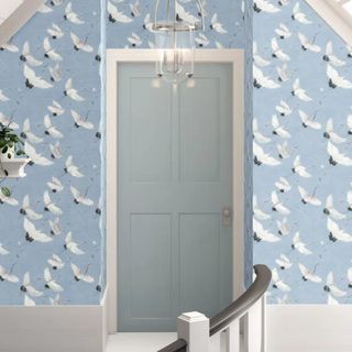Light blue wallpaper with a white bird pattern