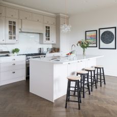 cream kitchen and island with black painted bar stools
