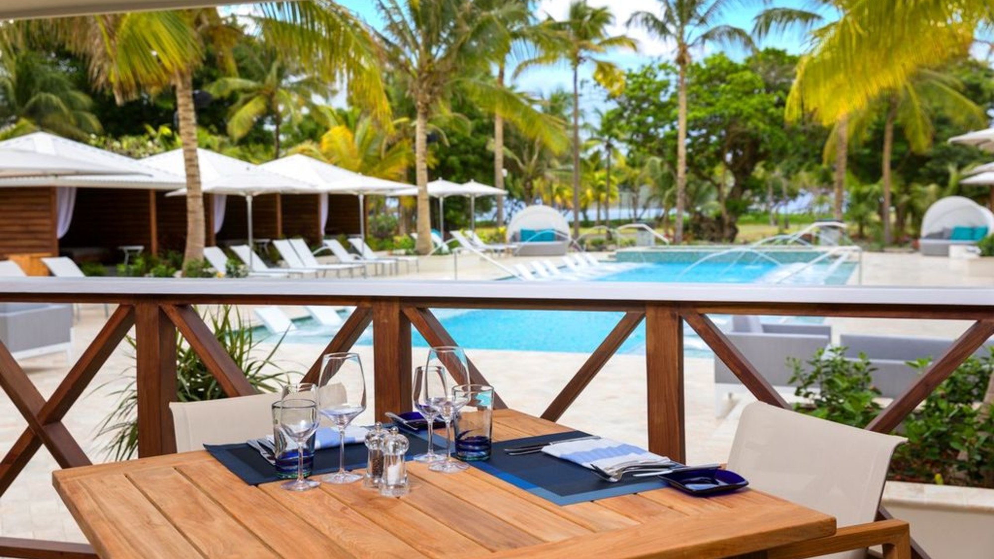 A table outside The Greathouse overlooking the pool at Serenity