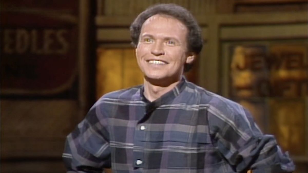 Billy Crystal smiling while hosting Saturday Night Live on March 17th, 1984.