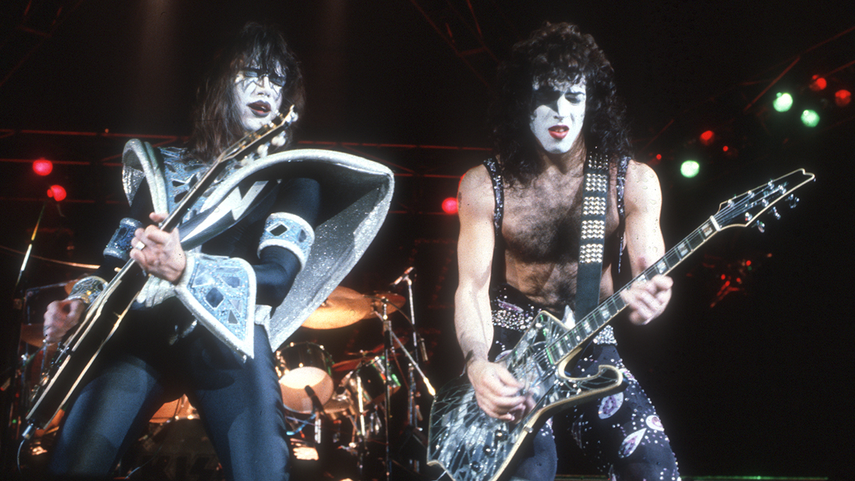 Ace Frehley (left) and Paul Stanley (right) from Kiss playing guitars on stage