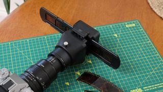 JJC Film Digitizing Adapter Set attached to a Fujifilm X-T5 camera on a green lined cutting mat