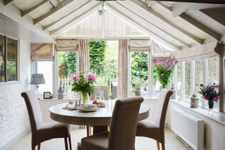 orangery vs conservatory — conservatory with white walls and hessian blinds