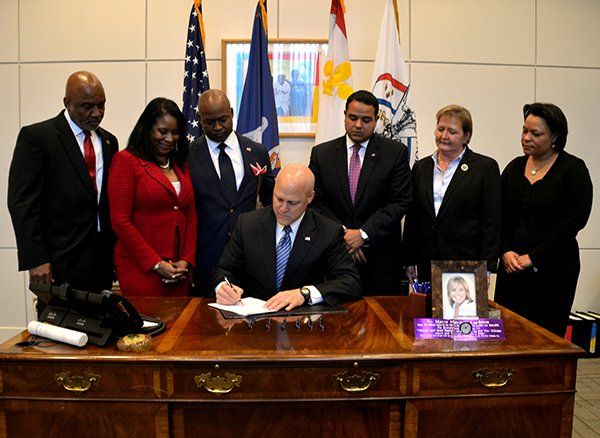 New Orleans Mayor Mitch Landrieu signs a proposal.