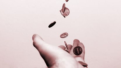 Coins falling into a hand