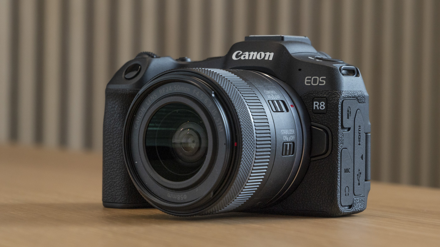 Canon EOS R8 on a table angled front view with lens attached