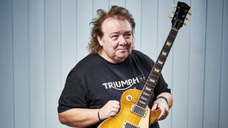 Bernie Marsden poses with a Gibson Les Paul