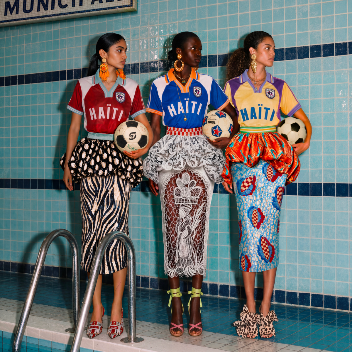 three women wear Stella Jean Haiti football shirts
