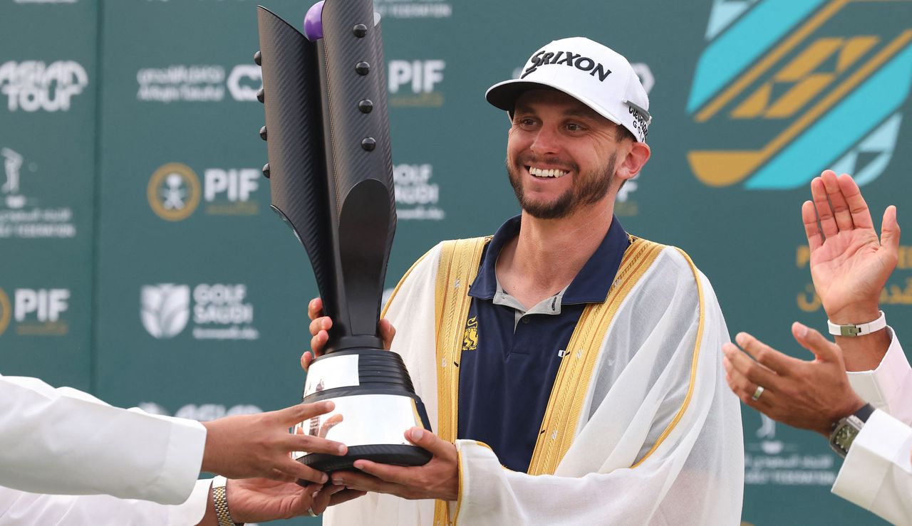 John Catlin holds the Saudi Open trophy