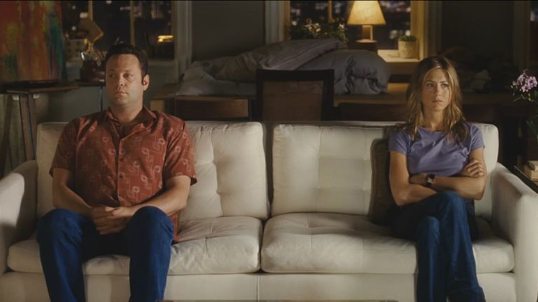 A picture of Vince Vaughn as Gary Grobowski and Jennifer Aniston as Brooke Meyers in the movie The Break Up sat on opposite ends of a settee.