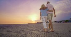 Older couple strolling on the beach