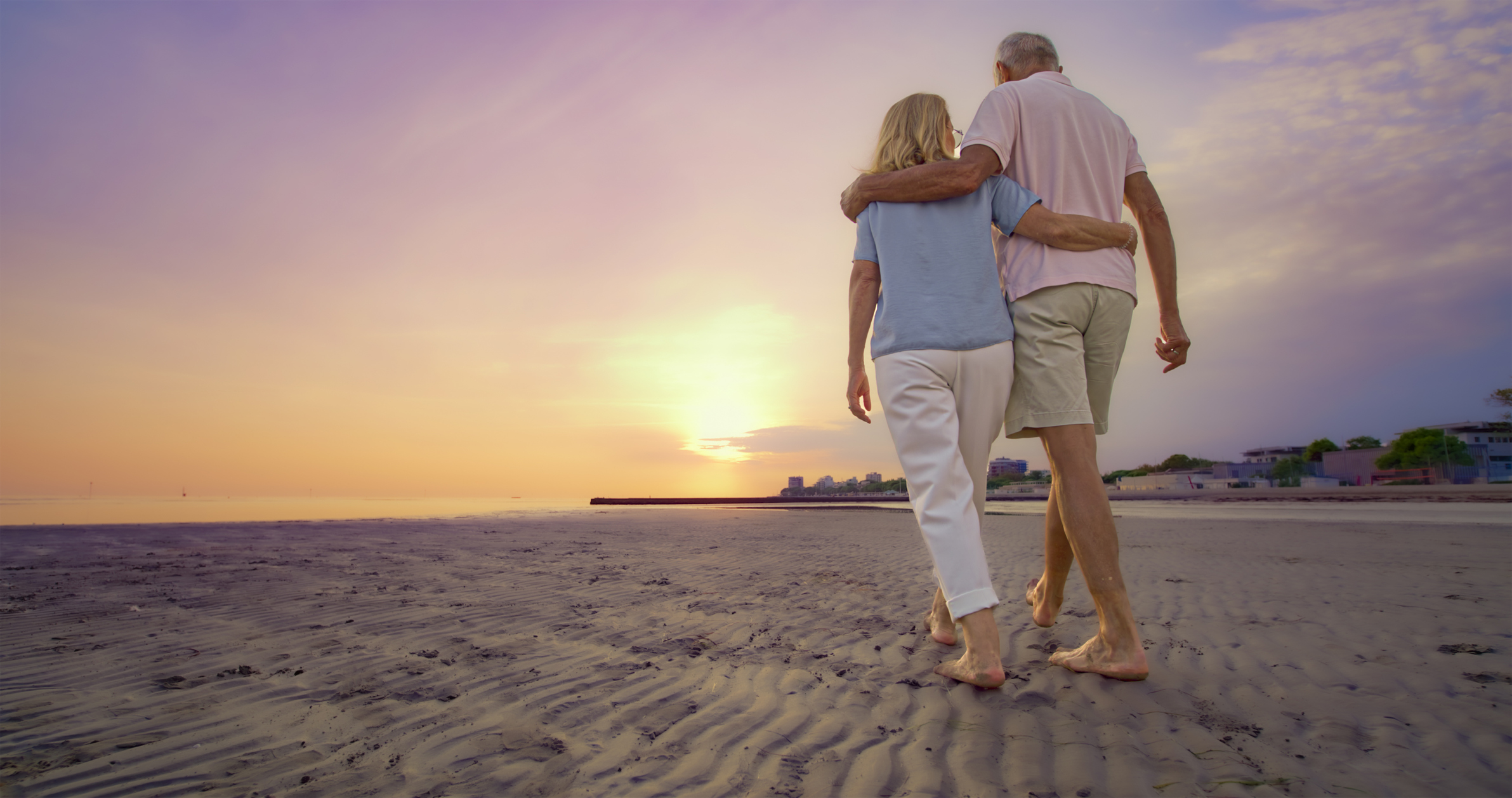 Older couple strolling on the beach