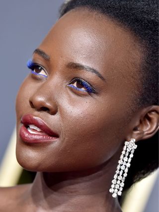 Lupita Nyong'o attends the 76th Annual Golden Globe Awards wearing blue mascara