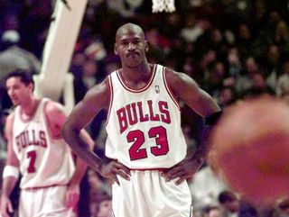 Chicago Bulls' Michael Jordan, center, watches the ball bounce away in the foreground Wednesday, Nov. 12, 1997, during the team's 90-83 loss to the Washington Wizards in Chicago. These are tough times