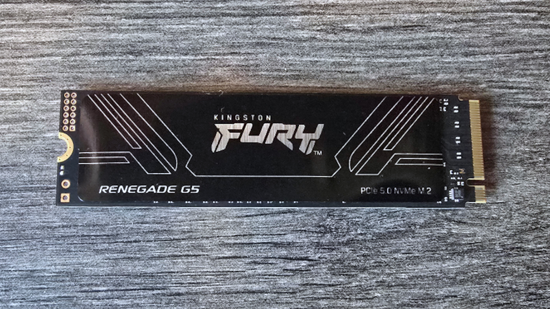 A photo of an 8 TB Kingston Fury Renegade G5 SSD, lying on a desk