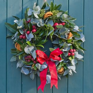 making a wreath for a door with a big ribbon