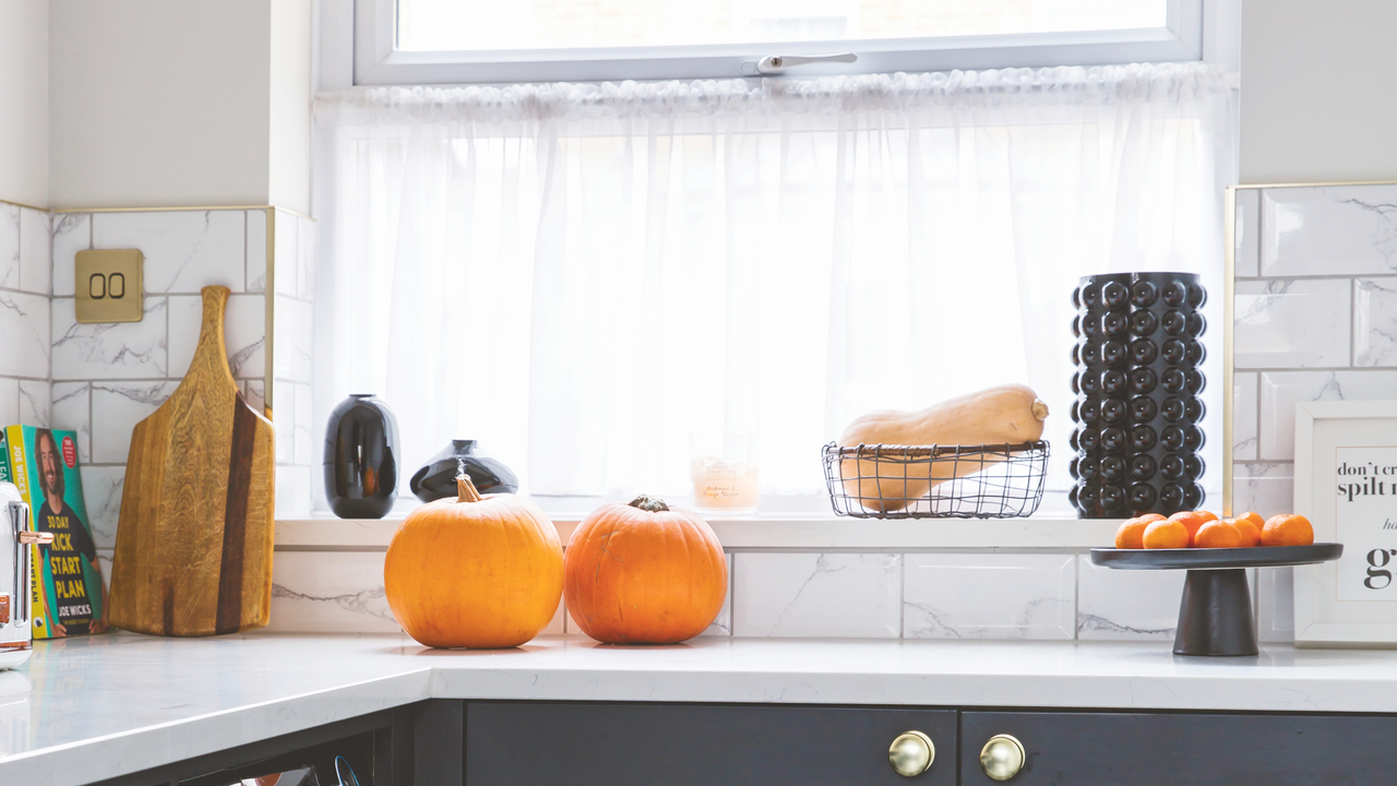 Two pumpkins on a white kitchen worktop