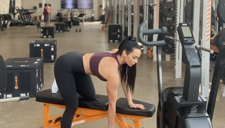 Woman exercises with kettlebells in gym