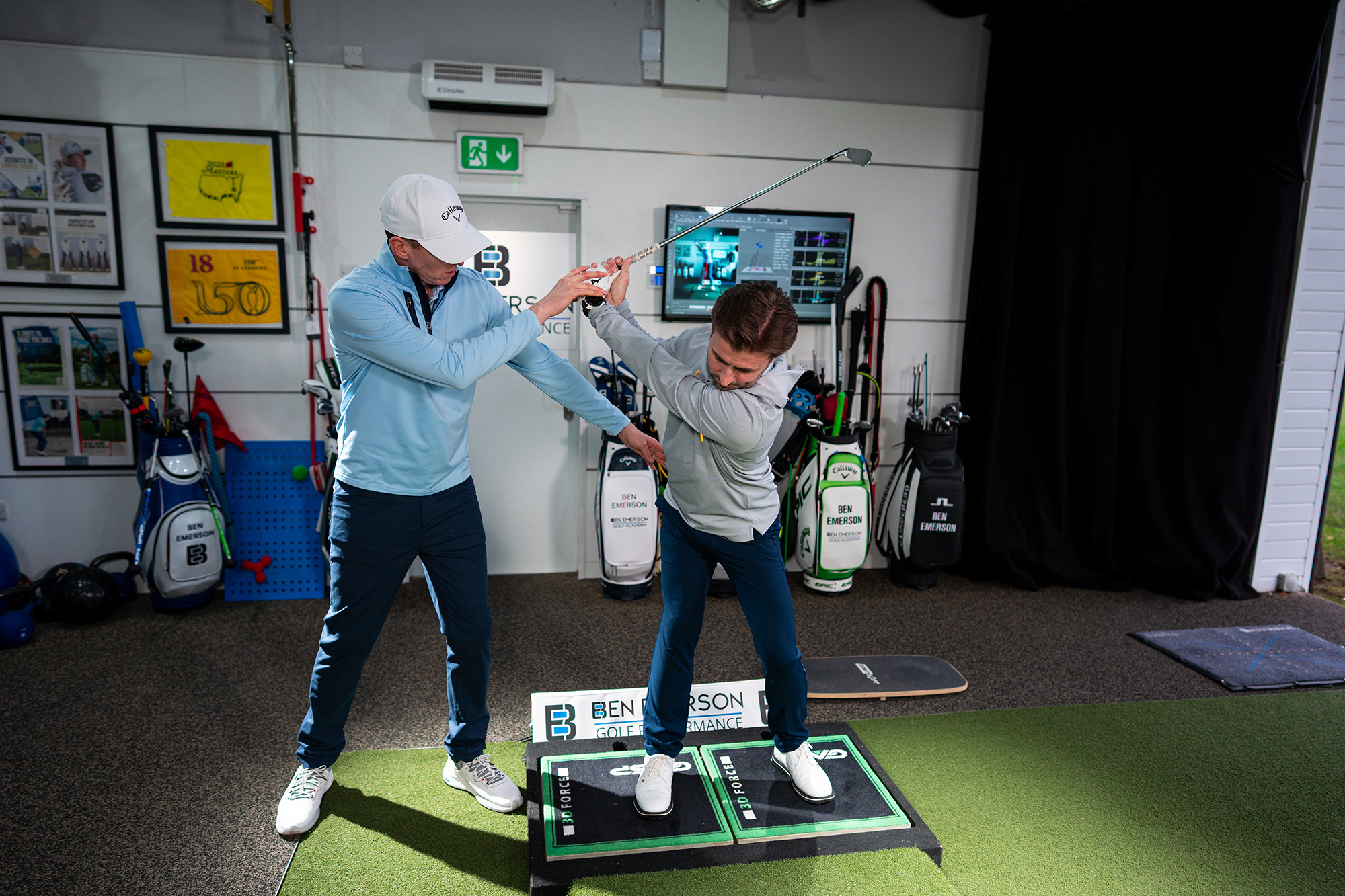 Ben Emerson manipulating our reader Neil into the correct position in the backswing to prevent a sway, during his golf lesson in Ben's studio