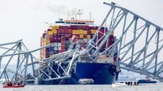 A cargo ship covered in the remnants of a bridge in Baltimore